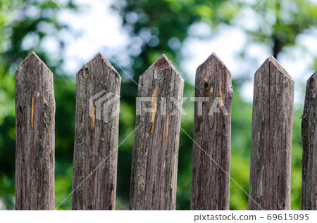 fence wooden stakes on the farm 69615095