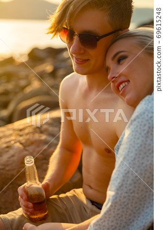 Young Smiling Woman Resting On Boyfriend's Shoulder At Beach Young Smiling Woman Resting On Boyfriend's Shoulder At Beach 69615248