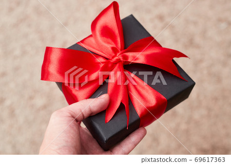 Black friday sale flat lay with gift box and ribbon, copy space, christmas and holidays concept Black friday sale flat lay with gift box and ribbon, copy space, christmas and holidays concept 69617363