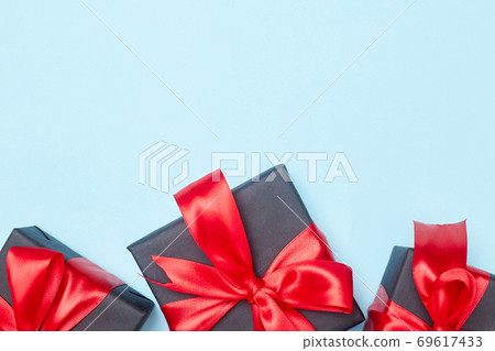 Black friday sale flat lay with gift box and ribbon, copy space, christmas and holidays concept on blue background Black friday sale flat lay with gift box and ribbon, copy space, christmas and holidays concept on blue background 69617433