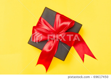Black friday sale flat lay with gift box and ribbon, copy space, christmas and holidays concept on yellow background 69617450