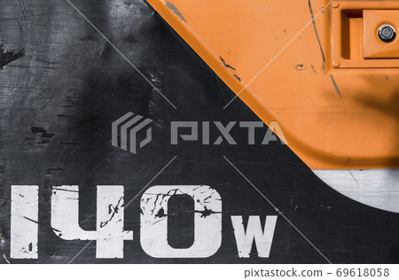 Part of old metal surface with an inscription 140w and keyhole. Abstract tech background. Part of old metal surface with an inscription 140w and keyhole. Abstract tech background. 69618058