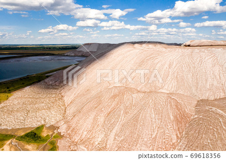 Mountains of products for the production of potash salt.Salt mountains near the city of Soligorsk.Production of fertilizer for the land. Belarus. Mountains of products for the production of potash salt.Salt mountains near the city of Soligorsk.Production of fertilizer for the land. Belarus. 69618356