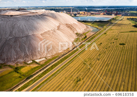 Mountains of products for the production of potash salt.Salt mountains near the city of Soligorsk.Production of fertilizer for the land. Belarus. Mountains of products for the production of potash salt.Salt mountains near the city of Soligorsk.Production of fertilizer for the land. Belarus. 69618358