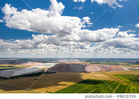 Mountains of products for the production of potash salt and artificial reservoirs.Salt mountains near the city of Soligorsk.Production of fertilizers for the Land. Belarus. Mountains of products for the production of potash salt and artificial reservoirs.Salt mountains near the city of Soligorsk.Production of fertilizers for the Land. Belarus. 69618359