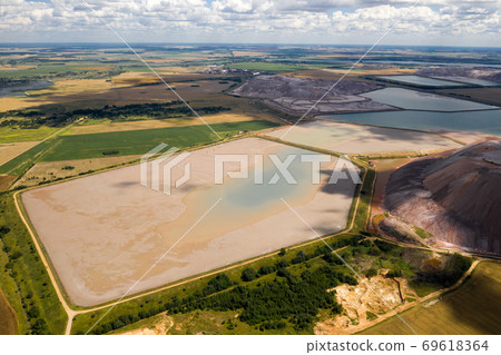 Mountains of products for the production of potash salt and artificial reservoirs.Salt mountains near the city of Soligorsk.Production of fertilizers for the Land. Belarus. 69618364