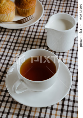 Cup of Tea and Milk with Cupcake for the Time of Tea Break. Cup of Tea and Milk with Cupcake for the Time of Tea Break. 69618369