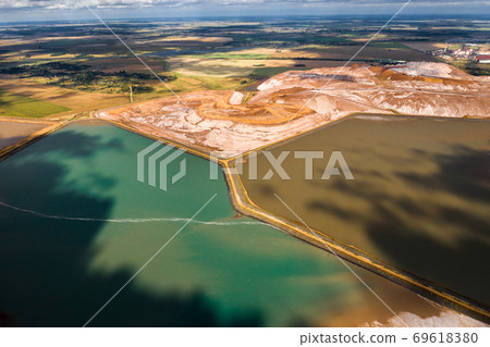 Mountains of products for the production of potash salt and artificial turquoise reservoirs.Salt mountains near the city of Soligorsk.Production of fertilizers for the Land. Belarus 69618380