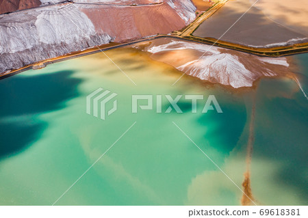 Mountains of products for the production of potash salt and artificial turquoise reservoirs.Salt mountains near the city of Soligorsk.Production of fertilizers for the Land. Belarus Mountains of products for the production of potash salt and artificial turquoise reservoirs.Salt mountains near the city of Soligorsk.Production of fertilizers for the Land. Belarus 69618381