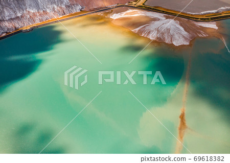 Mountains of products for the production of potash salt and artificial turquoise reservoirs.Salt mountains near the city of Soligorsk.Production of fertilizers for the Land. Belarus Mountains of products for the production of potash salt and artificial turquoise reservoirs.Salt mountains near the city of Soligorsk.Production of fertilizers for the Land. Belarus 69618382
