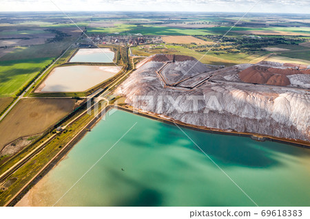 Mountains of products for the production of potash salt and artificial turquoise reservoirs.Salt mountains near the city of Soligorsk.Production of fertilizers for the Land. Belarus 69618383