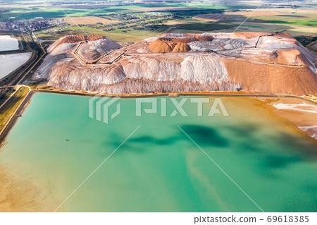 Mountains of products for the production of potash salt and artificial turquoise reservoirs.Salt mountains near the city of Soligorsk.Production of fertilizers for the Land. Belarus Mountains of products for the production of potash salt and artificial turquoise reservoirs.Salt mountains near the city of Soligorsk.Production of fertilizers for the Land. Belarus 69618385