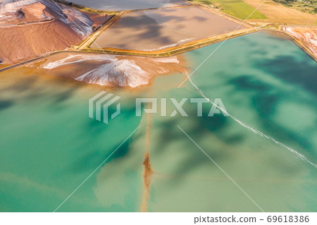 Mountains of products for the production of potash salt and artificial turquoise reservoirs.Salt mountains near the city of Soligorsk.Production of fertilizers for the Land. Belarus 69618386