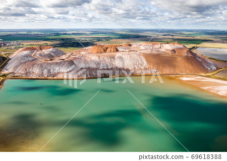 Mountains of products for the production of potash salt and artificial turquoise reservoirs.Salt mountains near the city of Soligorsk.Production of fertilizers for the Land. Belarus Mountains of products for the production of potash salt and artificial turquoise reservoirs.Salt mountains near the city of Soligorsk.Production of fertilizers for the Land. Belarus 69618388