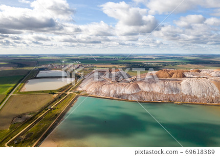 Mountains of products for the production of potash salt and artificial turquoise reservoirs.Salt mountains near the city of Soligorsk.Production of fertilizers for the Land. Belarus Mountains of products for the production of potash salt and artificial turquoise reservoirs.Salt mountains near the city of Soligorsk.Production of fertilizers for the Land. Belarus 69618389