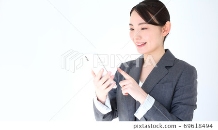 Image of a business woman operating a smartphone 69618494