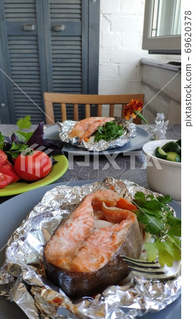 Homemade foil baked salmon steak, home cooking concept, selective focus Homemade foil baked salmon steak, home cooking concept, selective focus 69620378