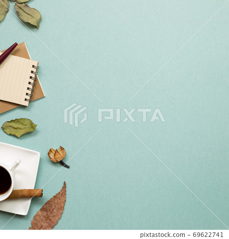 Autumn concept. Notebook and black coffee with dry leaves on green background. flat lay, top view, copy space. Work and study place Autumn concept. Notebook and black coffee with dry leaves on green background. flat lay, top view, copy space. Work and study place 69622741