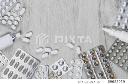 Medicine. Pills with phonendoscope on grey wood Medicine. Pills with phonendoscope on grey wood 69622959