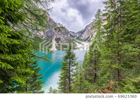Beautiful view through the forest to Lake Braies in the Italian Alps Beautiful view through the forest to Lake Braies in the Italian Alps 69623360