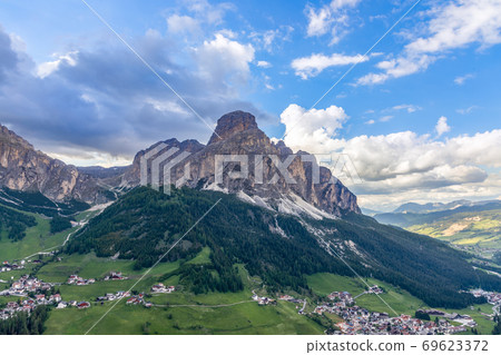 View of the alpine villages of Colfosco and Corvara at the foot of the mountain Sassongher 69623372