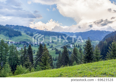 Alpine meadows and hills under the evening sky. Italian Alps, Italian Dolomites, Corvara in Badia Alpine meadows and hills under the evening sky. Italian Alps, Italian Dolomites, Corvara in Badia 69623528