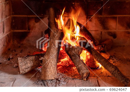 View of a burning fireplace. Texture of a burning tree. Bright fire 69624047