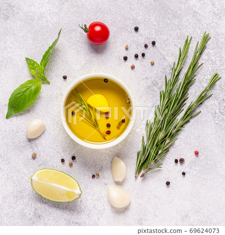 Herbs and condiments on light stone background. 69624073