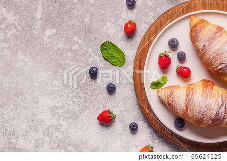 Breakfast with croissants and fresh fruits. Breakfast with croissants and fresh fruits. 69624125