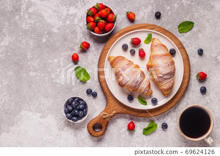 Breakfast with croissants and fresh fruits. Breakfast with croissants and fresh fruits. 69624126