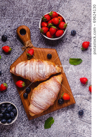 Breakfast with croissants and fresh fruits. Breakfast with croissants and fresh fruits. 69624130