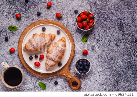 Breakfast with croissants and fresh fruits. Breakfast with croissants and fresh fruits. 69624131