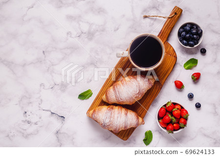 Breakfast with croissants and fresh fruits. Breakfast with croissants and fresh fruits. 69624133