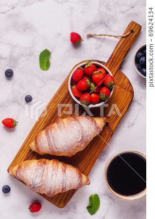 Breakfast with croissants and fresh fruits. Breakfast with croissants and fresh fruits. 69624134