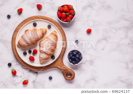 Breakfast with croissants and fresh fruits. Breakfast with croissants and fresh fruits. 69624137