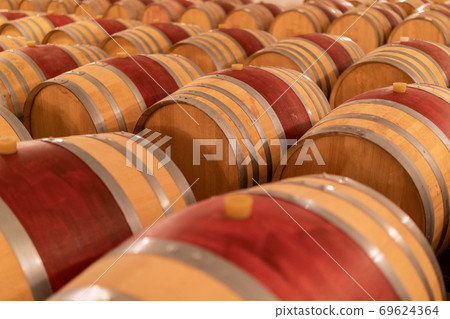 Wine barrels stacked in the old cellar of the winery. (Selective focus) 69624364
