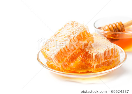 Fresh honey and honeycomb isolated on white background Fresh honey and honeycomb isolated on white background 69624387