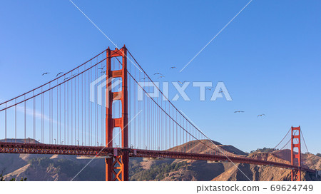 View of famous Golden Gate Bridge in San Francisco in the rays of the setting sun 69624749