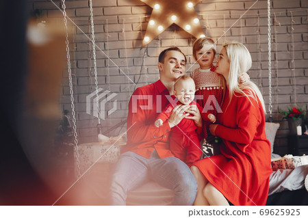 Family sitting at home on a bed Family sitting at home on a bed 69625925