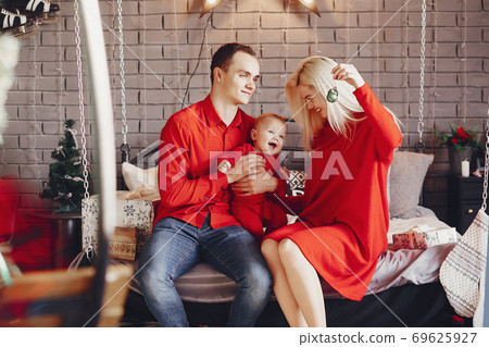 Family sitting at home on a bed Family sitting at home on a bed 69625927