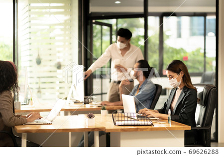 Social distance office with business team wear face mask as new normal life 69626288