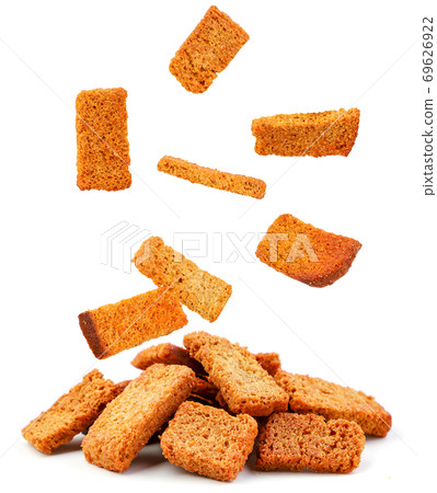 Bread croutons fall on a heap on a white background. Isolated 69626922