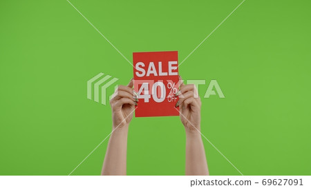 Sale 40 Percent Off advertisement inscription on paper sheet in womans hands on chroma key 69627091