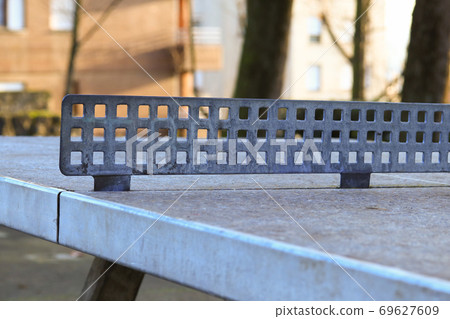 Ruined old abandoned ping pong table in the courtyard, with the focus of the aperture on the network Ruined old abandoned ping pong table in the courtyard, with the focus of the aperture on the network 69627609