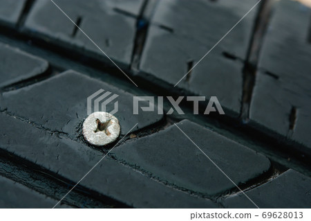 Close up metal screws nails embroidered in tires Close up metal screws nails embroidered in tires 69628013
