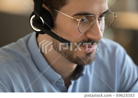 Close up of Caucasian man in headset talk online 69628383