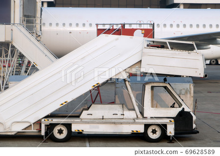 Passenger ladders for boarding passengers in an airplane. Airplane stairs prepared for boarding. Passenger ladders for boarding passengers in an airplane. Airplane stairs prepared for boarding. 69628589
