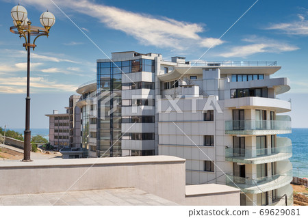 Modern building construction on sea shore Modern building construction on sea shore 69629081