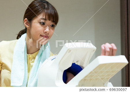 A woman measuring blood pressure A woman measuring blood pressure 69630097