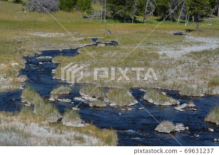Scalding water flowing in a thermal desert at Upper Geyser Basin in Yellowstone National Park, Wyoming Scalding water flowing in a thermal desert at Upper Geyser Basin in Yellowstone National Park, Wyoming 69631237